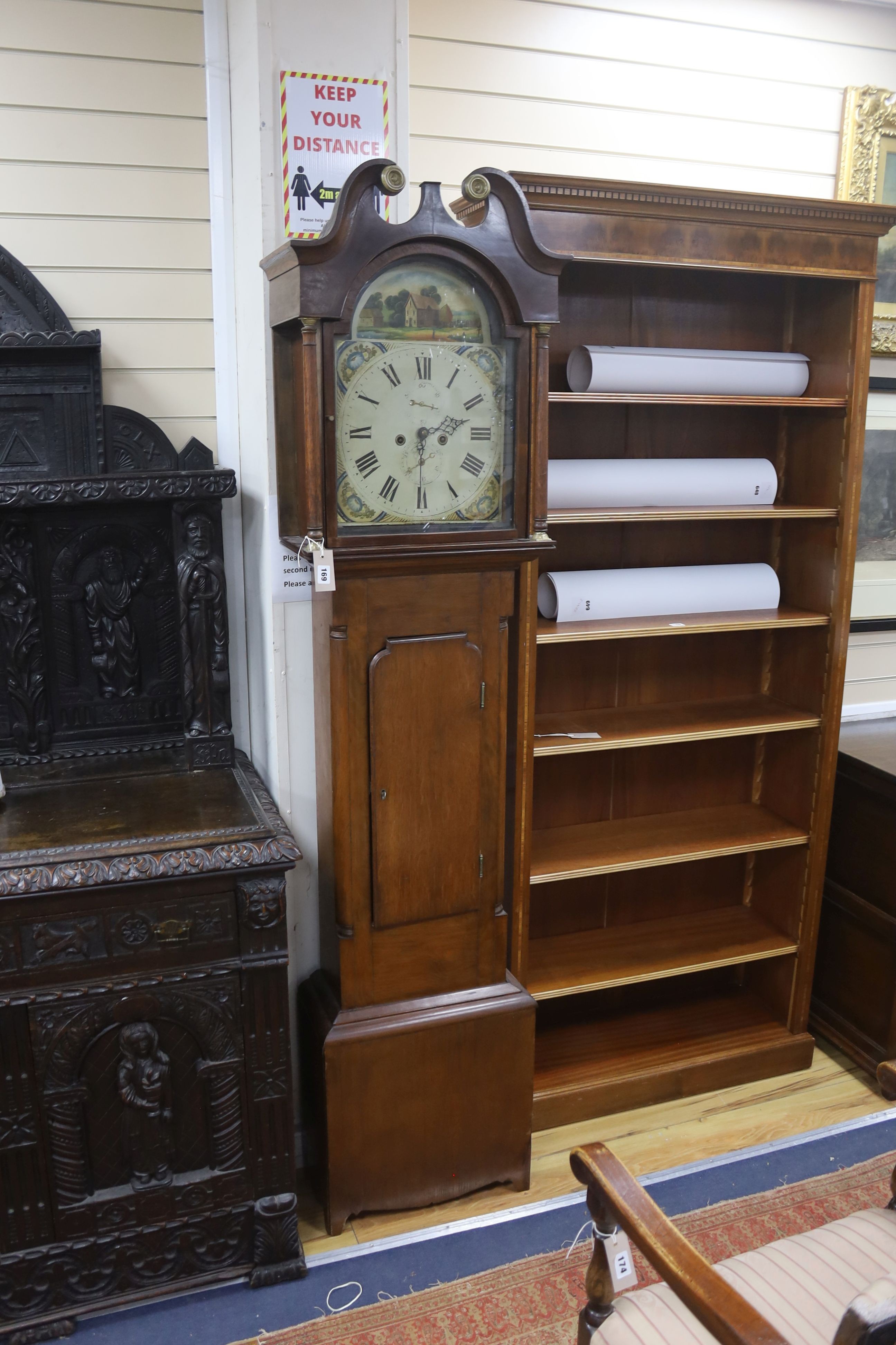 An early 19th century 8-day oak longcase clock, painted dial, with key, pendulum and weights, height 207cm